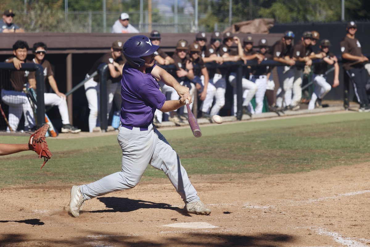 Cole DeYoung connects at the plate at Crespi, the ball just off his bat, with the Crespi dugout watching from behind the rail.