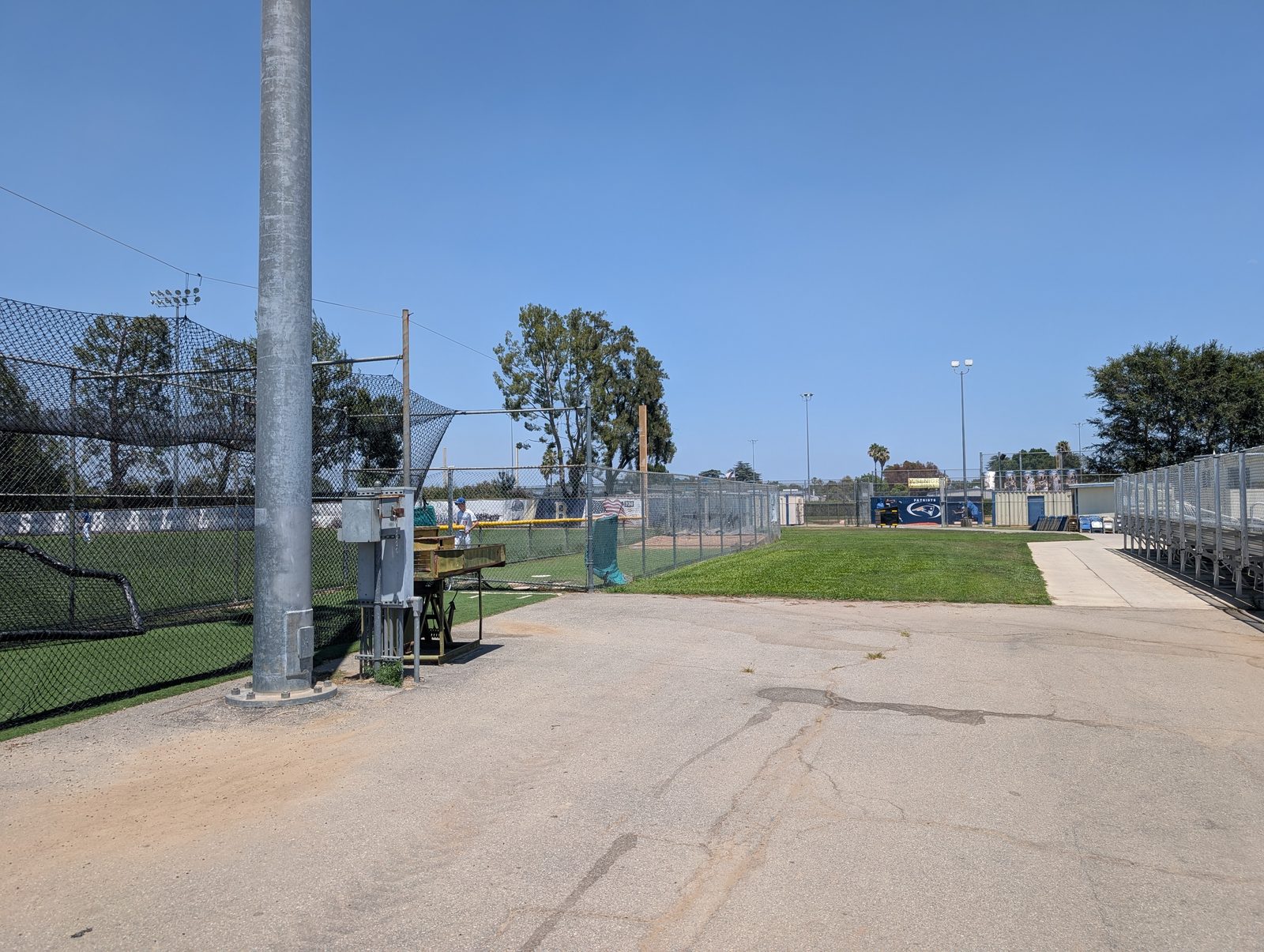 The gate-and-walkway approach in from the second (dumpster) lot. Two big gates, typically open, lead onto the walkway.