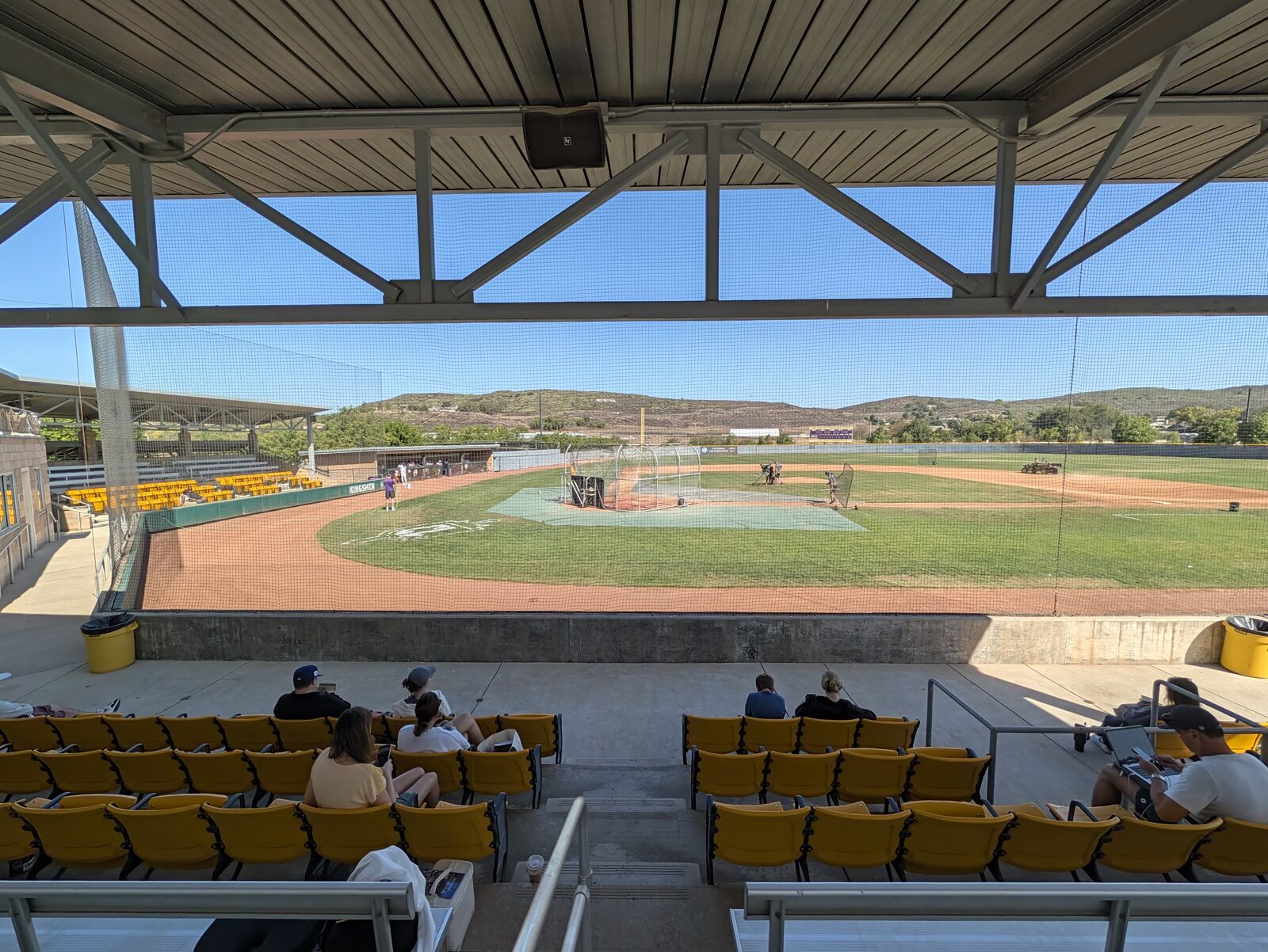 From under the grandstand roof behind home plate. This roof is the reason you do not need an umbrella here.