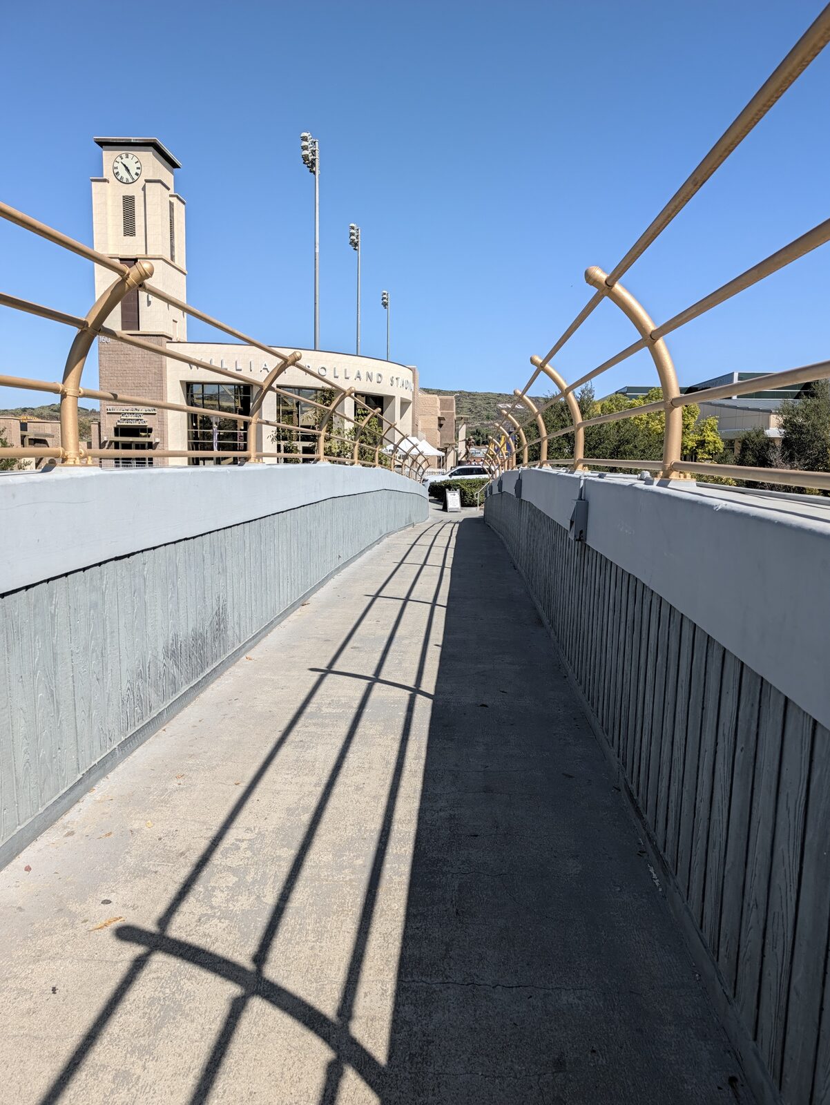 The campus bridge looking toward William Rolland Stadium. Clock tower, light towers, and entirely the wrong stadium: baseball is on north campus.