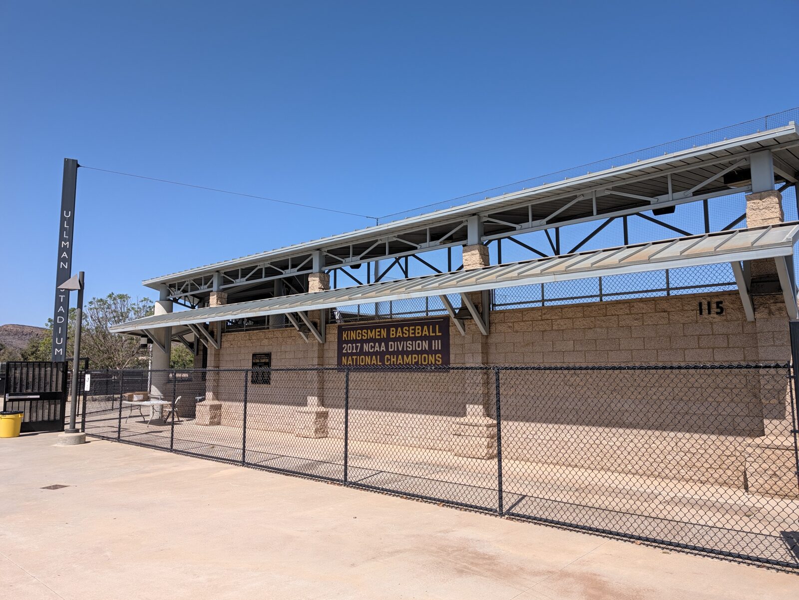 The sign that tells you that you found the right stadium: ULLMAN STADIUM, with the 2017 NCAA Division III national champions banner on the wall. The 115 on the building is the street number: 115 Overton Court.