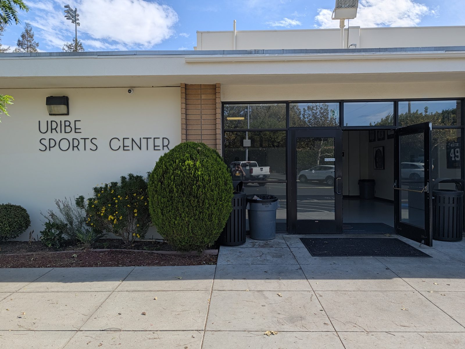 The Uribe Sports Center, right off the school lot. The restrooms are inside.