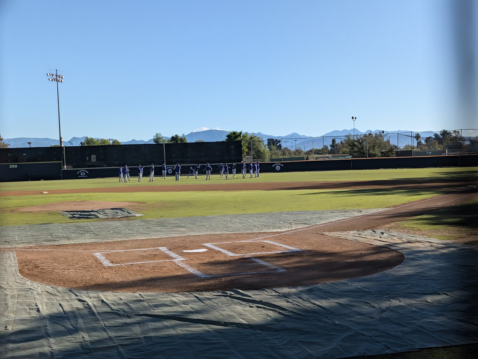 The field from behind home plate, mountains out past the outfield wall.