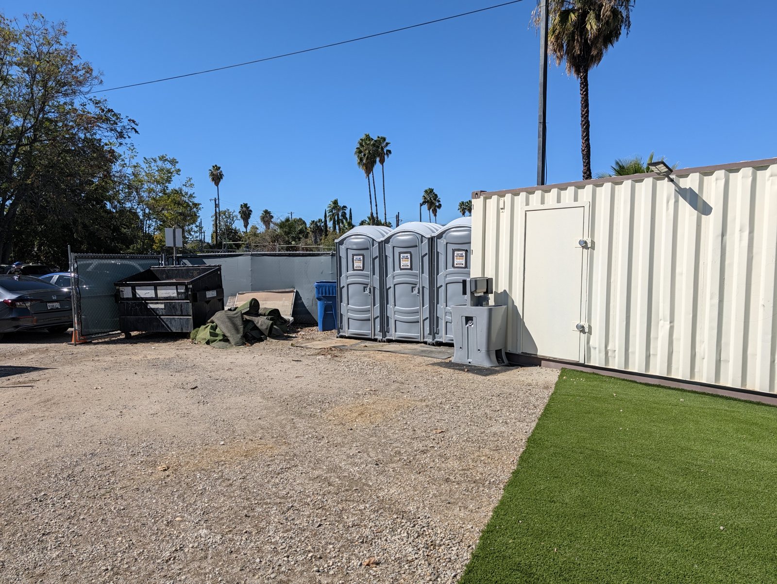 The three portable restrooms, with a hand-washing station, just past the food.