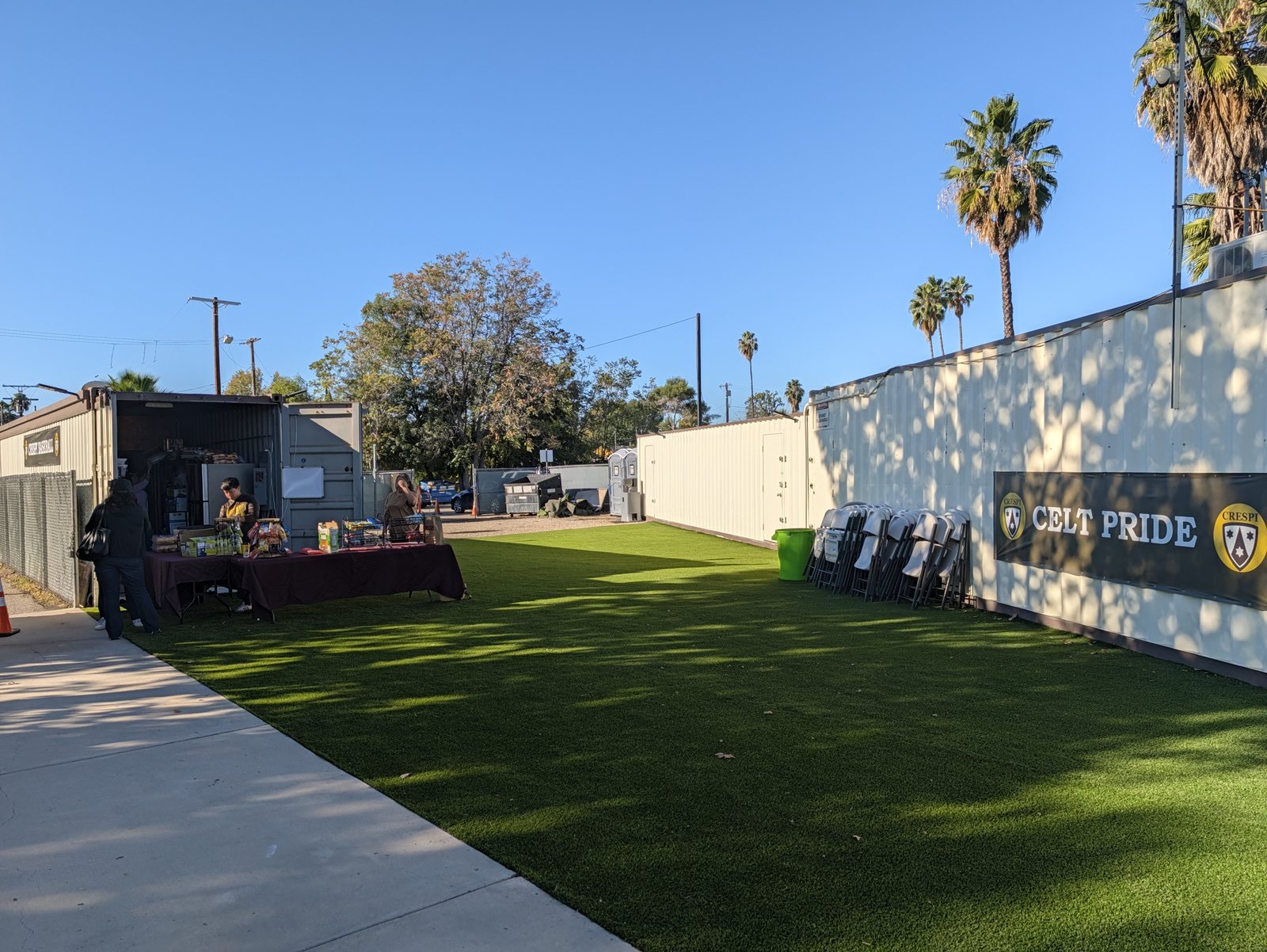 The snack bar. A table set up outside, with the stock coming out of the trailer behind it.