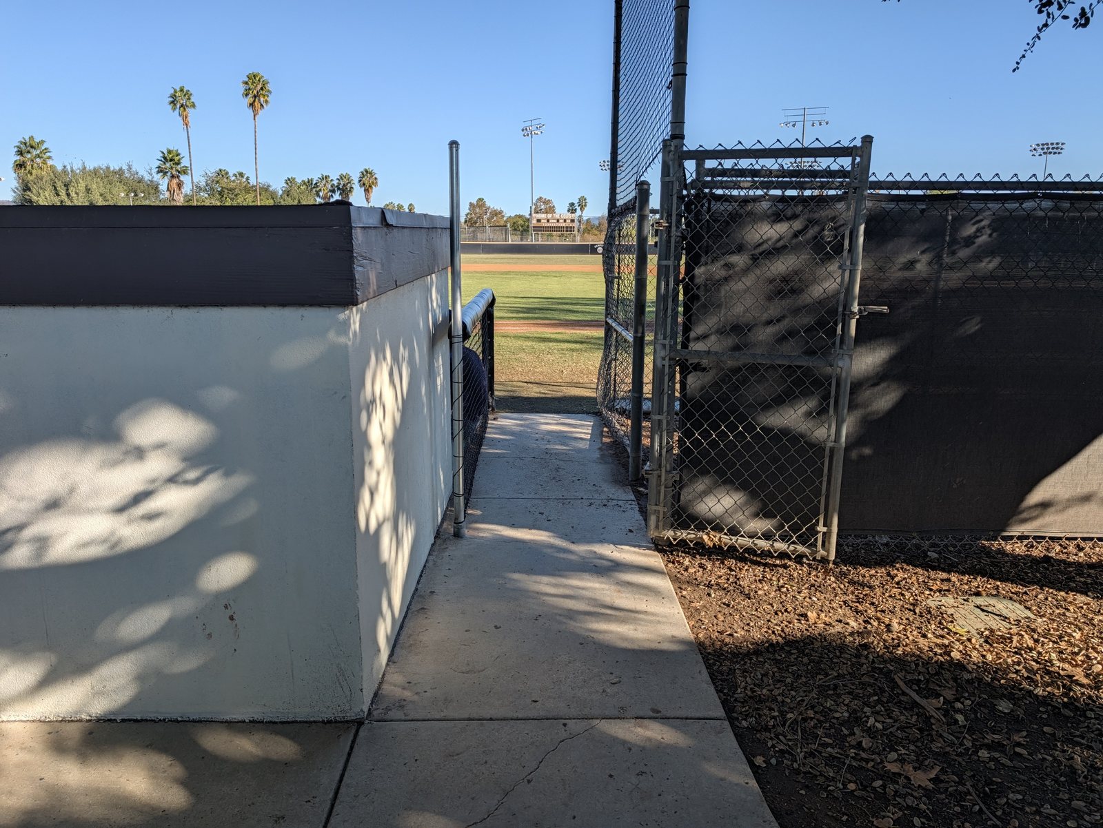 The walkway in, between the back of the stands and the gate.
