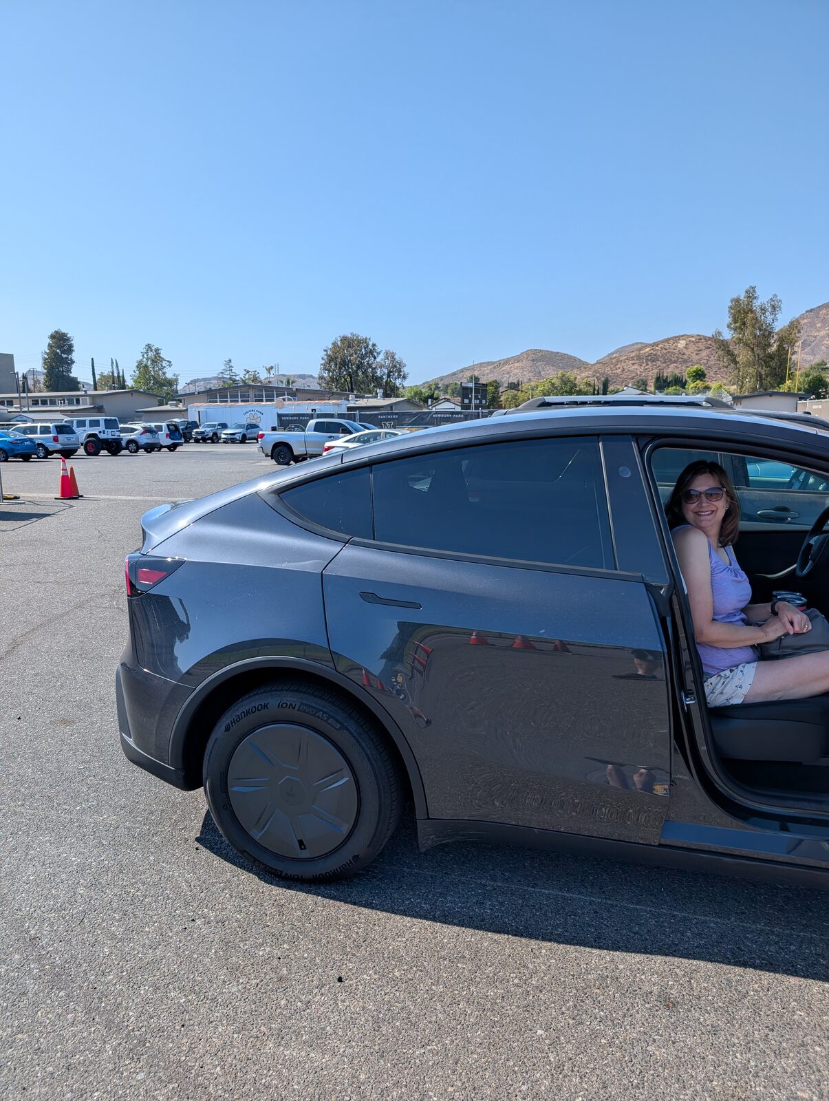 Arrival in the visitor lot, with the field-lights tower and the Conejo Valley hills behind the field. Plenty of parking, about a one-minute walk.