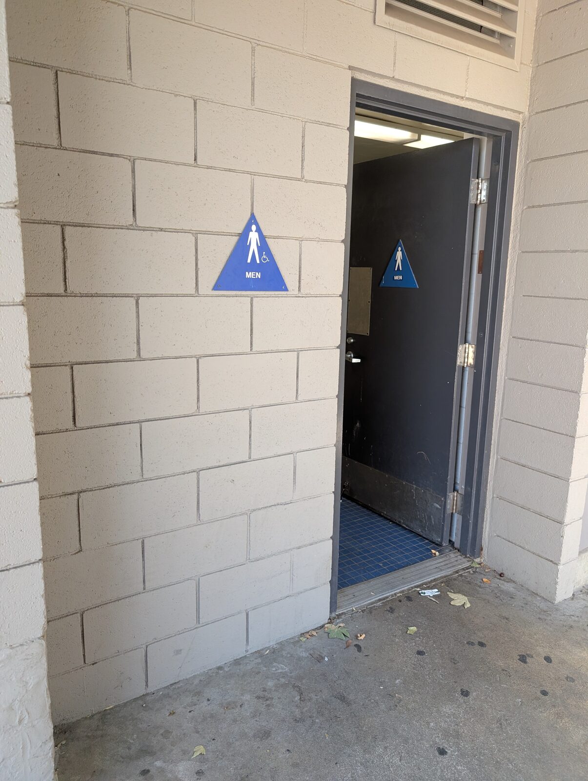 The men's restroom entrance: clean, accessible, and well-marked.
