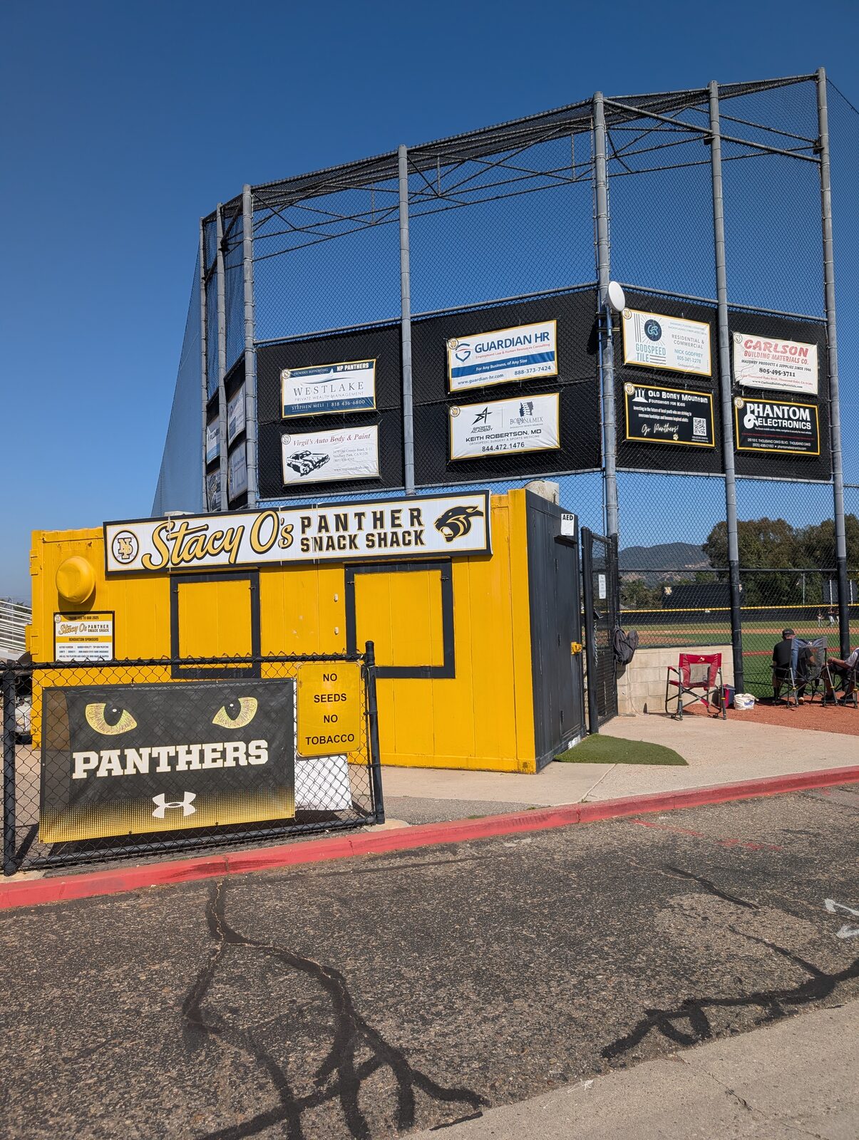 Stacy O's Panther Snack Shack behind the backstop. A permanent fixture, but closed for the summer game.