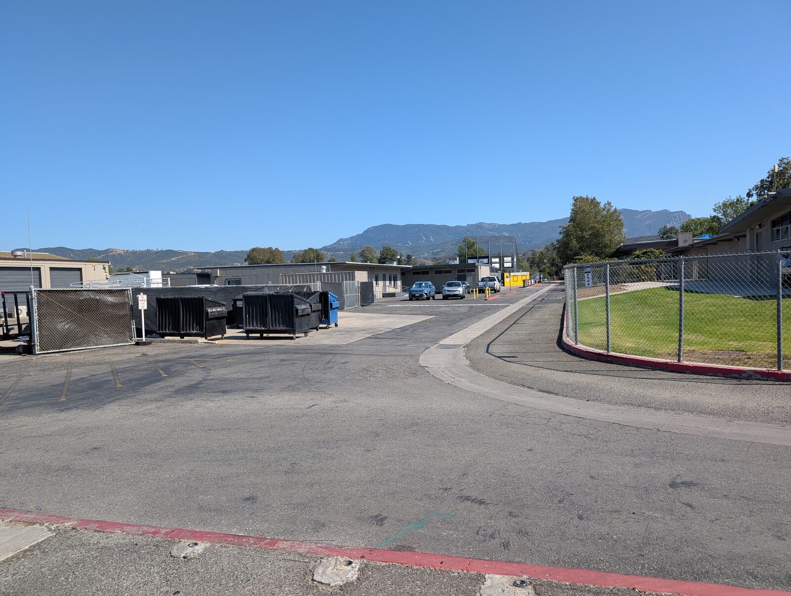 The short walk from the parking area toward the school buildings, roughly the start of the one-minute walk to the field.